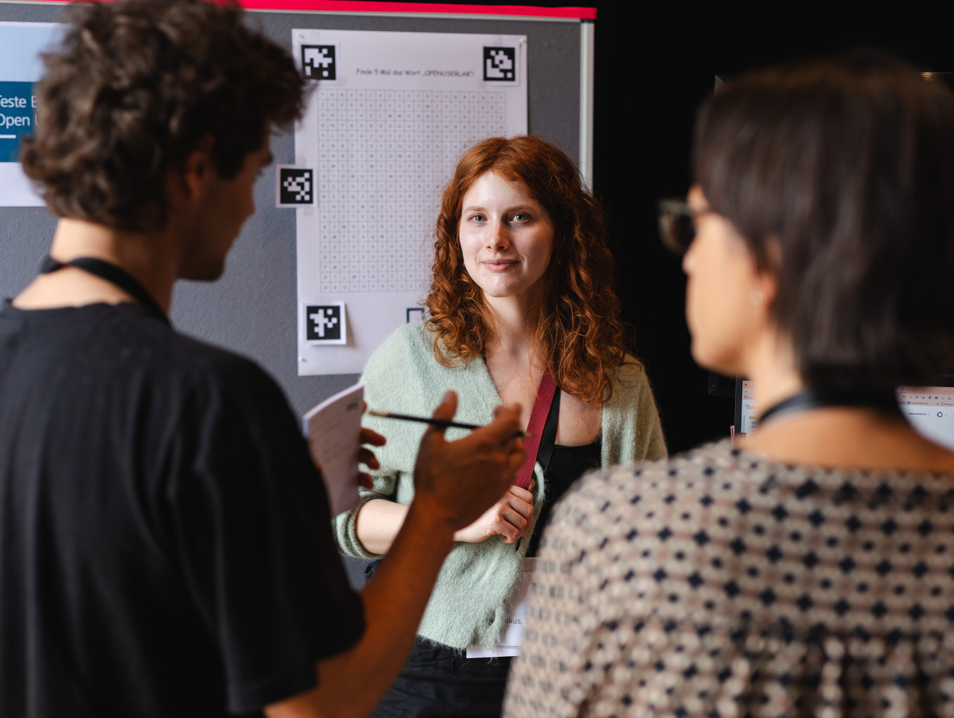 2 woman and a men talking to each other 