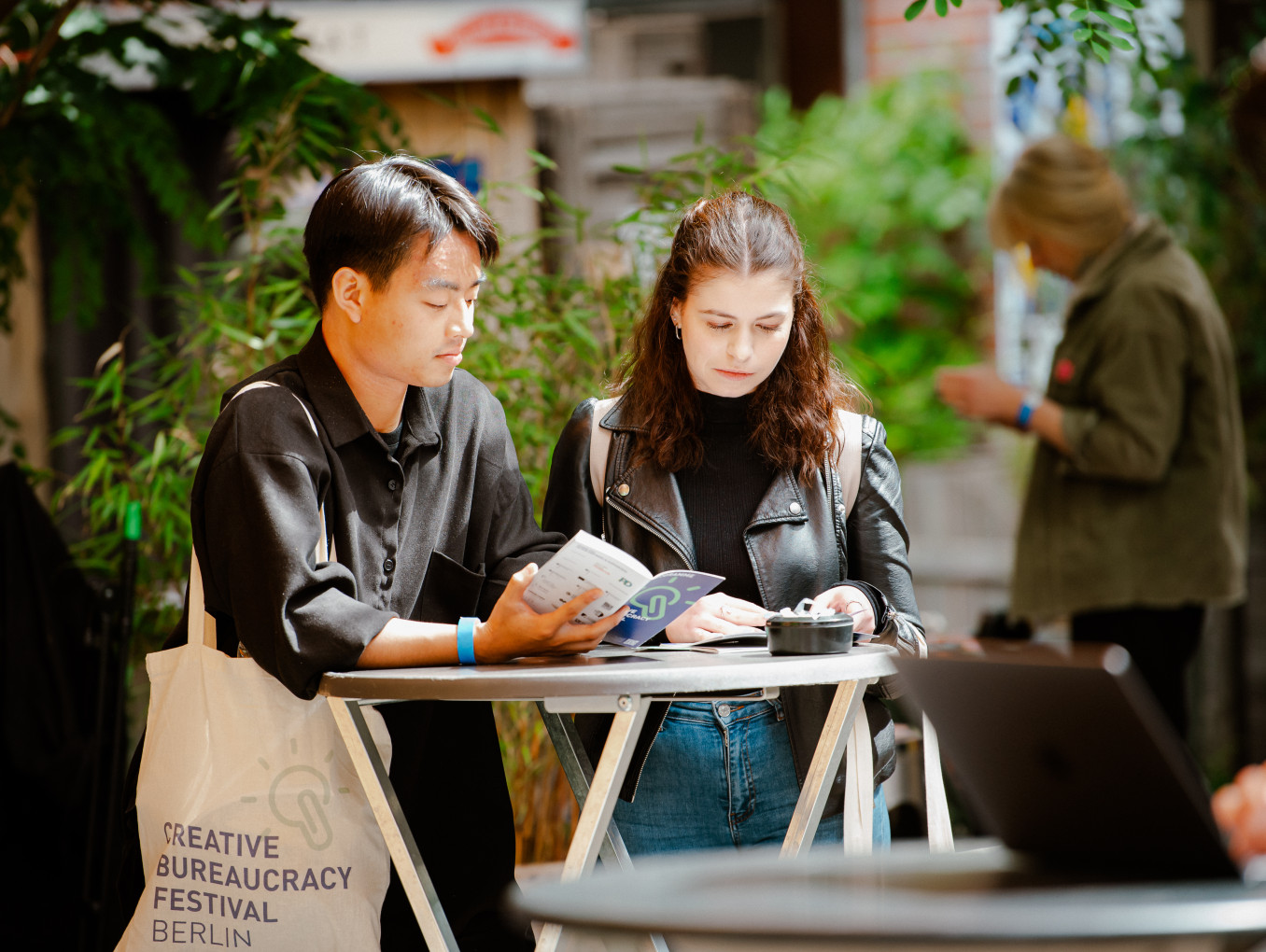 two young people reading the programme of the festival 