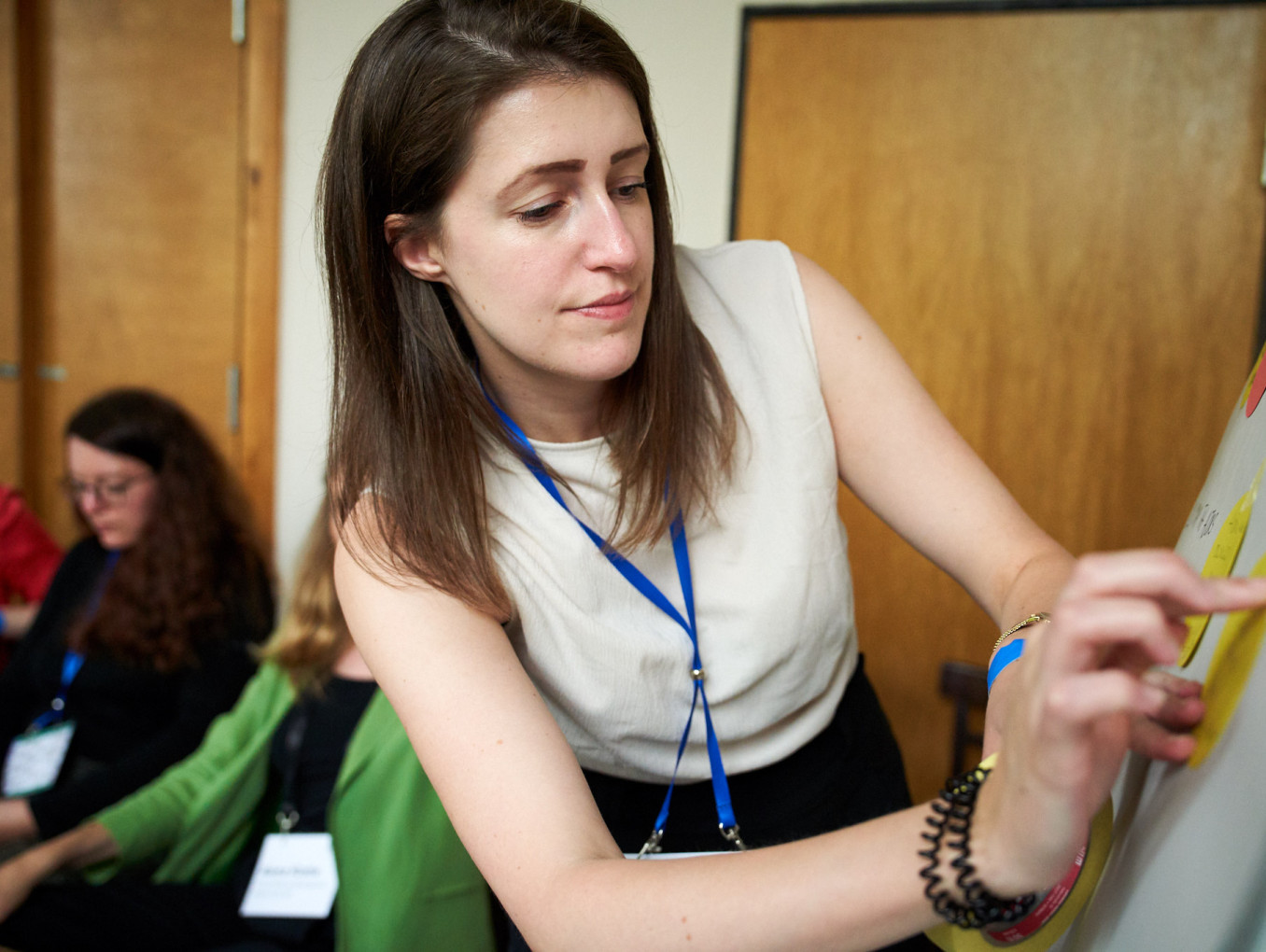 Woman pointing to board