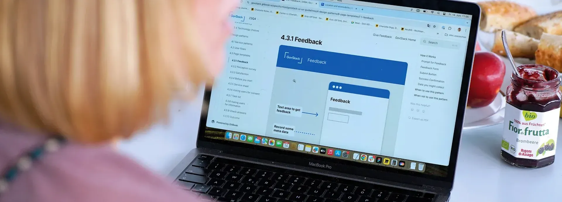 woman sitting infront of a computer with a feedback from website open
