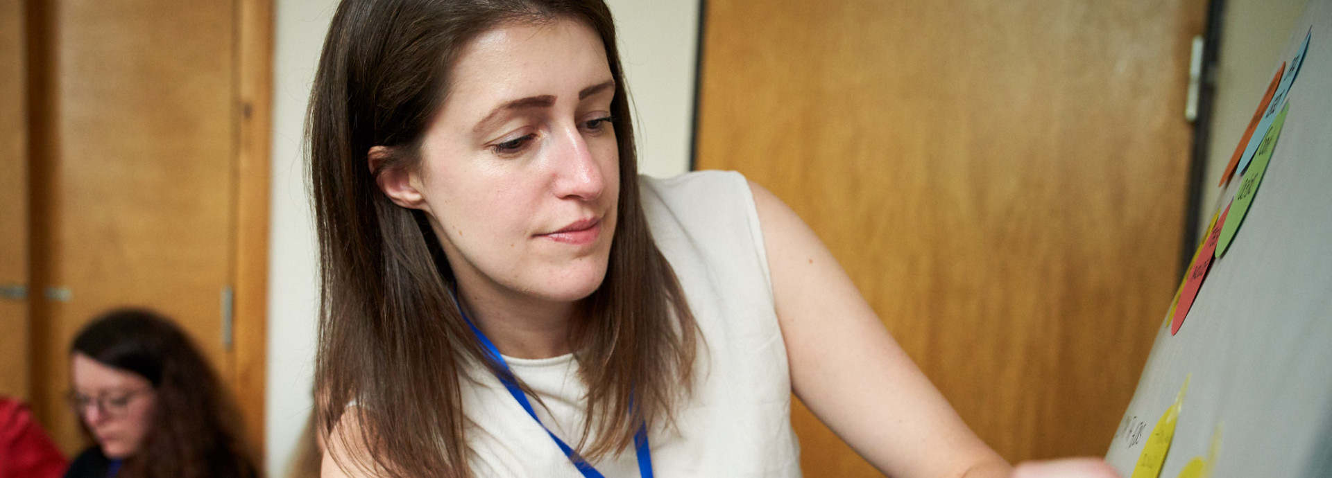 Woman pointing to board