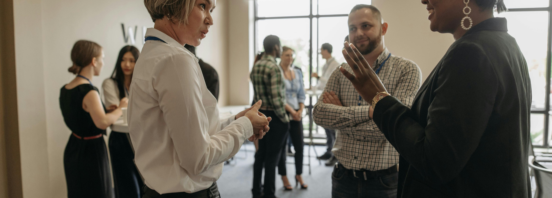 A diverse group of people talking in a room. 