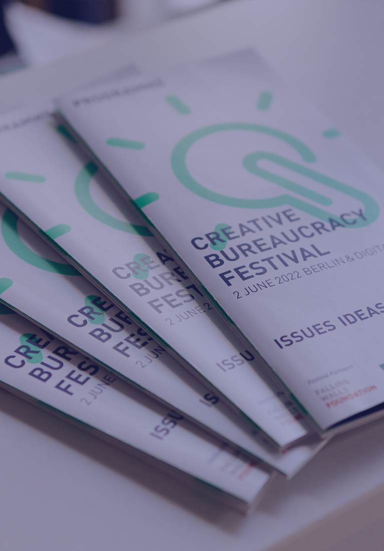 four print programmes lying on a counter