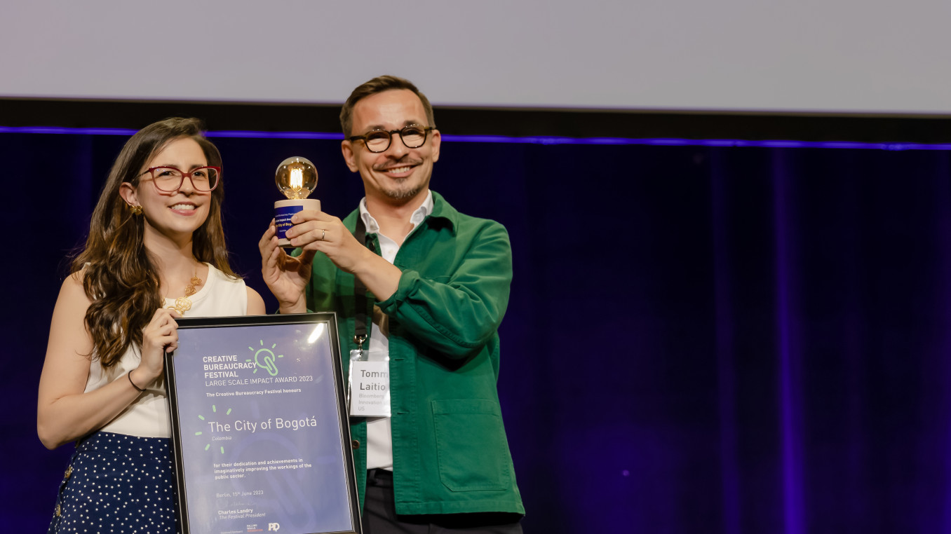 man and woman receiving the creative bureaucracy festival award 2023