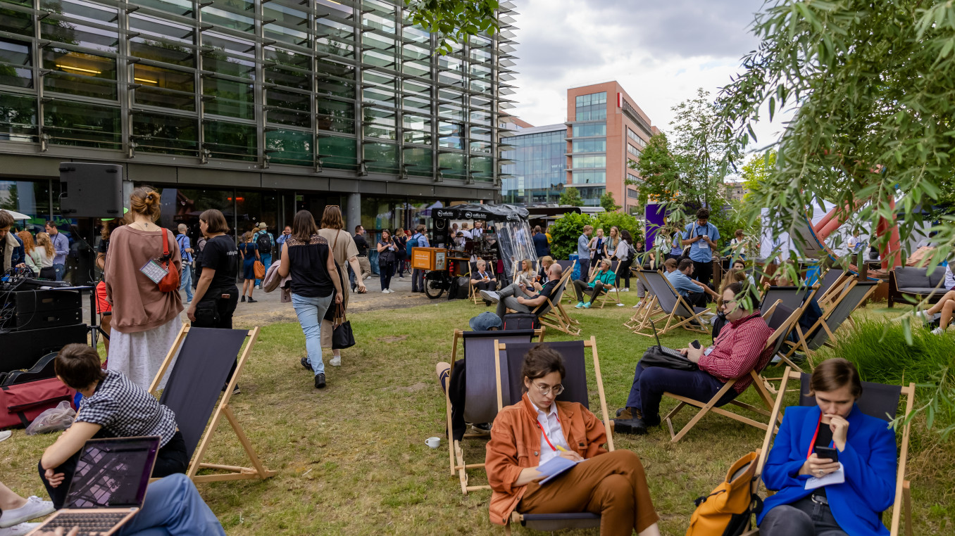 outside area of the festival 2023, people sitting, walking outside, networking and working 