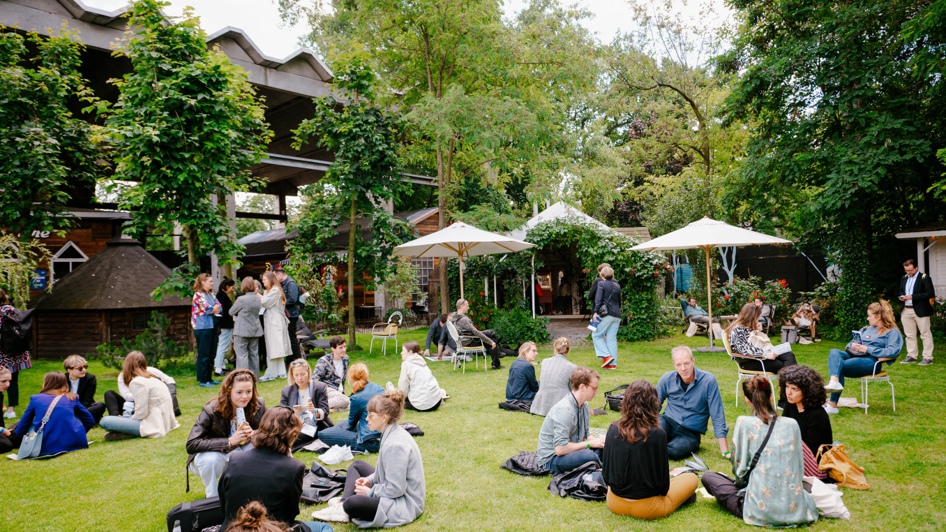 People sitting and standing on the grass 