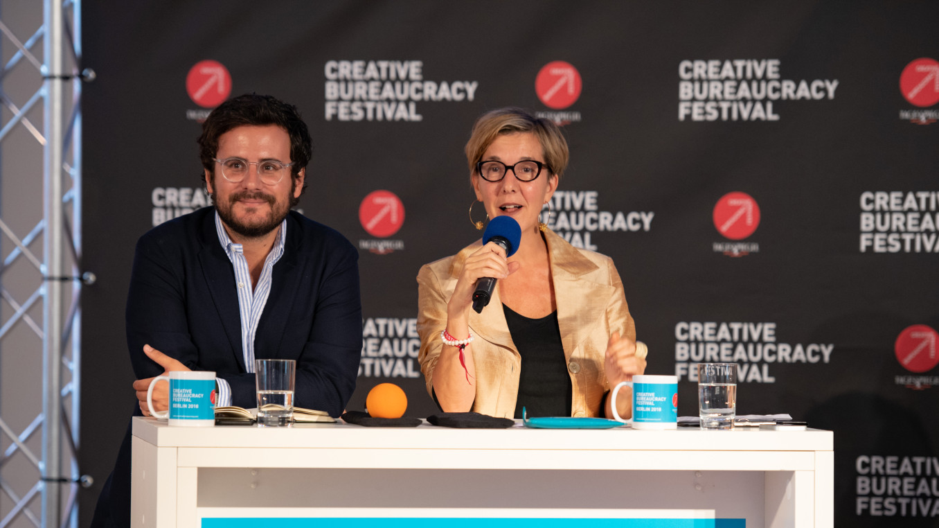 two speakers (man and woman) on stage 