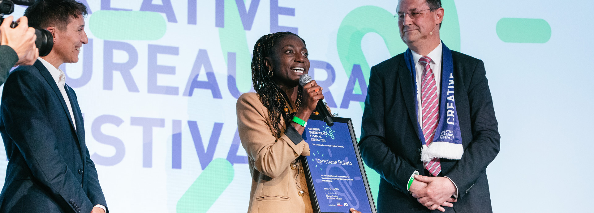 Christiana Bukalo receiving the award on stage